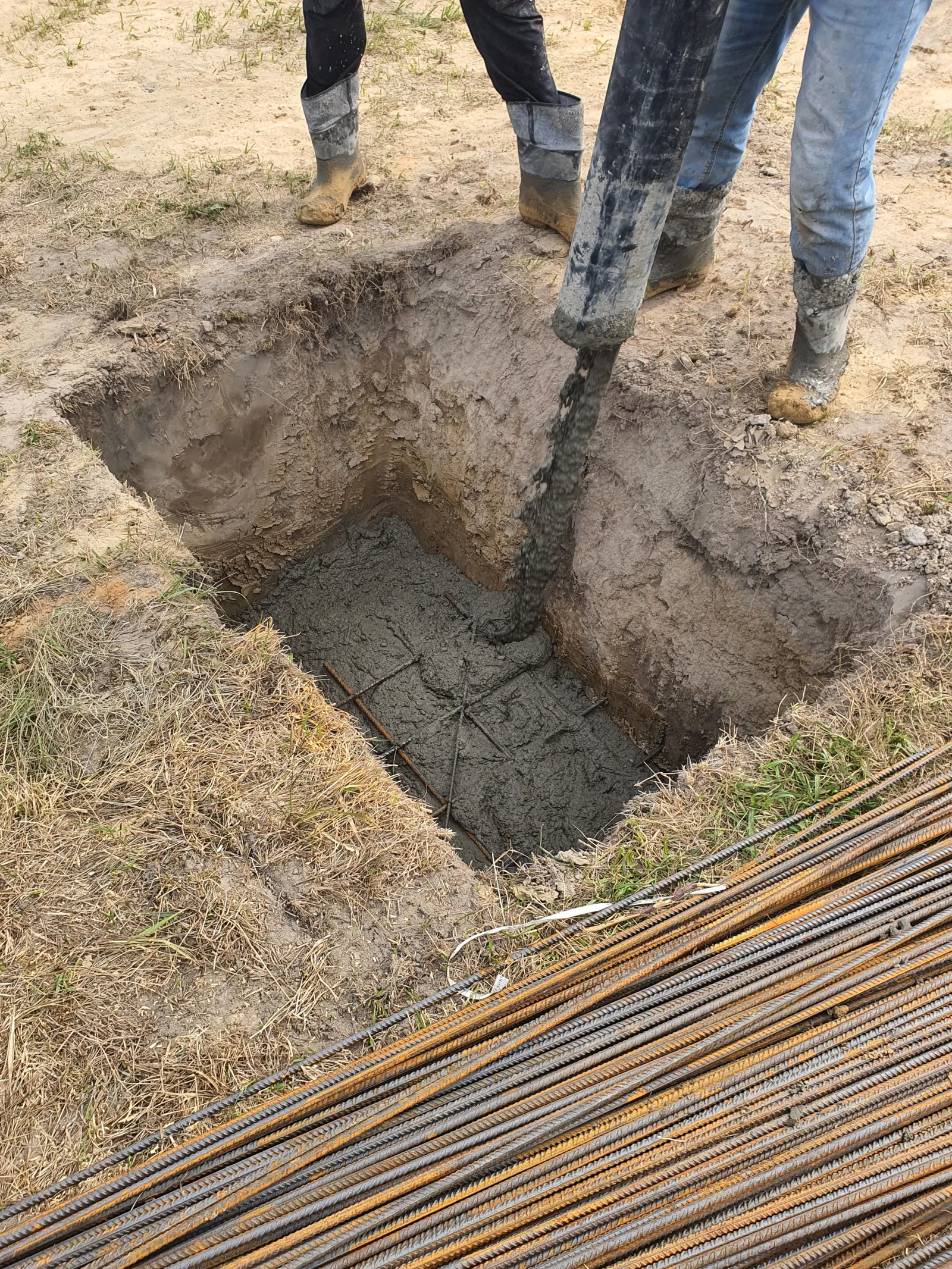 Concrete being poured into a piled foundation excavation on a domestic site