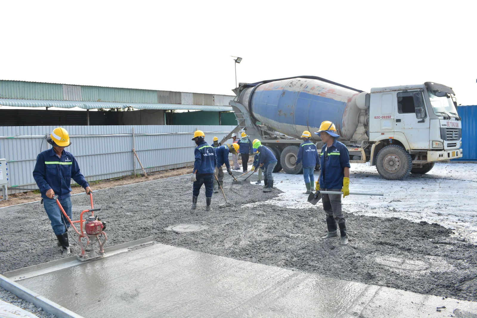 Foundation crew placing concrete on site
