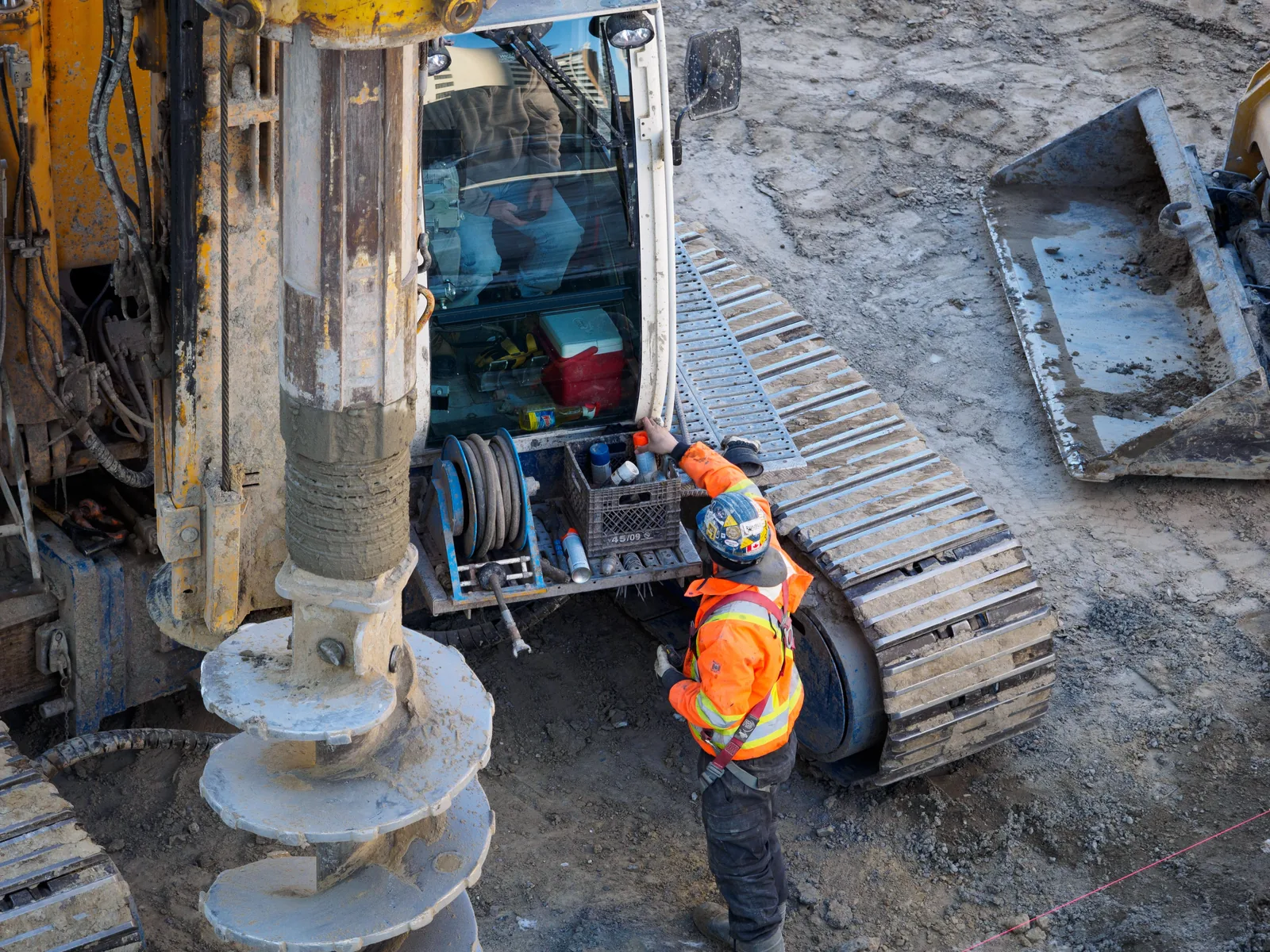 Continuous flight auger piling rig boring a pile on site